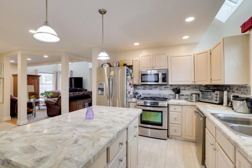 a kitchen with white cabinets and a counter top at 3 Mi to Beach Golfers Paradise in Lake View! in Lake View