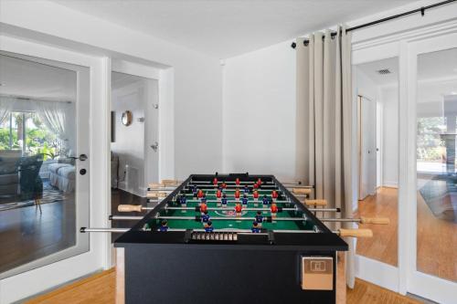a pool table in a living room at Ben's Bungalow - 8min to Siesta Key - Gigabit Wifi in Sarasota