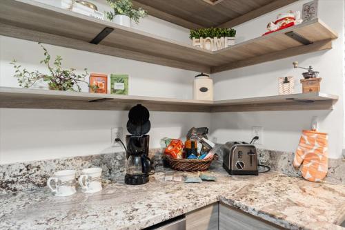 a kitchen with a counter top with a sink at Ben's Bungalow - 8min to Siesta Key - Gigabit Wifi in Sarasota