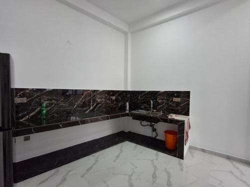 a bathroom with a sink and a black and white wall at Rahmath villa in Wennawatta