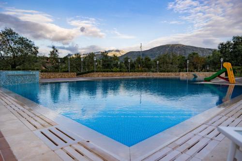 a large swimming pool with a slide in the middle at B&B Lilium Luxury Accomodations in Itri