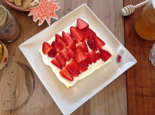 a cake with strawberries on a plate on a table at 20dimare in Cesenatico