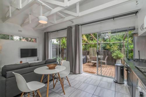 a living room with a couch and a table at Sitatunga Guest Lodge in Johannesburg