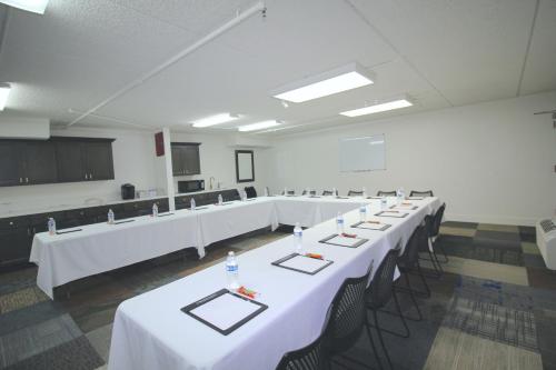 a large room with white tables and chairs in it at L3 Oasis Hotel in Palm Springs