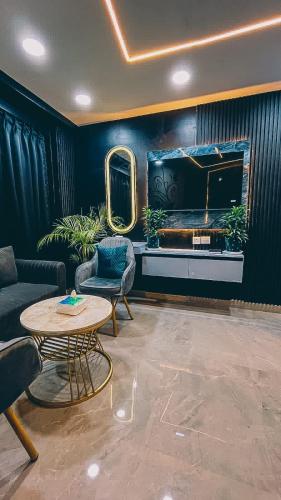 a living room with a table and a television at Sky-high studio in Ghaziabad