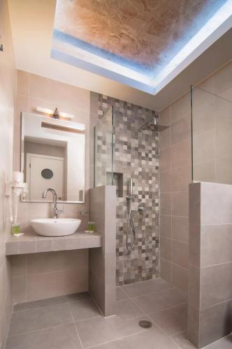 a bathroom with a sink and a shower at Skopelitis Village in Katapola
