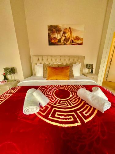 a bedroom with a large bed with a red blanket at OneLuxStay near Antwerp Central in Antwerp