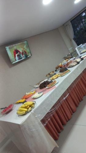 a buffet line with bananas and other food items at Trade Hotel Diadema in Diadema