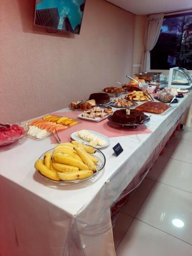 a buffet table with bananas and other food on it at Trade Hotel Diadema in Diadema