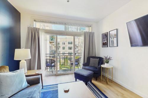 a living room with a couch and a chair and a window at Sapphire of Belltown Court in Seattle
