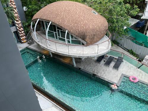 an overhead view of a swimming pool with a circular building at EMERALD TERRACE CONDO 52-FAMILY 1 Bedroom POOL VIEW in Patong Beach