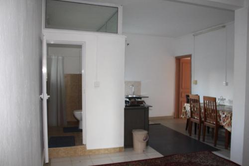 a living room with a door leading to a kitchen at Bano Tourist Residence - 650 meters from Grand Bay Beach in Grand Baie