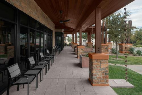 a row of chairs sitting outside of a building at TownePlace Suites by Marriott Carlsbad in Carlsbad