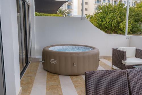 a hot tub on the balcony of a building at Pernera One Suites in Pernera Protaras in Paralimni