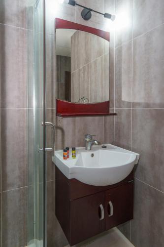 a bathroom with a sink and a mirror at Pernera One Suites in Pernera Protaras in Paralimni