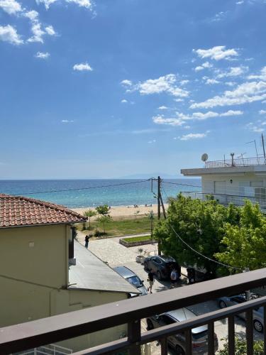 a view of the beach from the balcony of a condo at Sunset Apartments in Paralia Dionysiou
