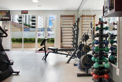 a gym with a bunch of equipment in a room at Hotel Itaim Swimming pool Cozy in Sao Paulo