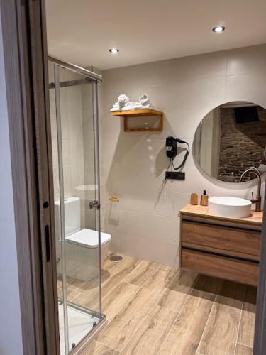 a bathroom with a shower and a toilet and a sink at A Casa do Pillado in Golada