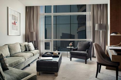 a living room with a couch and chairs and a large window at The St. Regis Mexico City in Mexico City