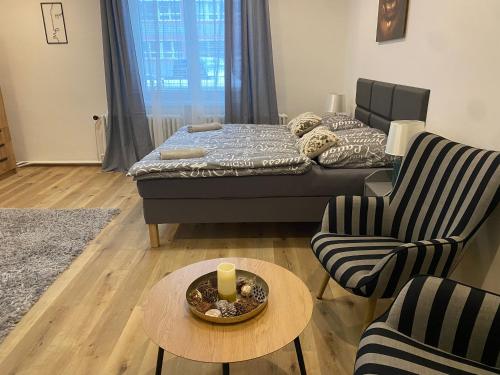 a living room with a bed and a table and chairs at Černá Růže- apartmán 2 in Plzeň