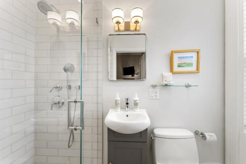 a white bathroom with a sink and a shower at Nantucket Resort Collection in Nantucket