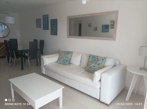 a living room with a white couch and a table at Look Brava in Punta del Este
