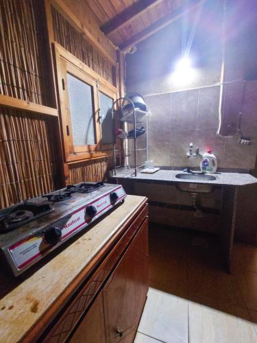 a kitchen with a stove and a sink at Garden House Camp 2 in Dahab