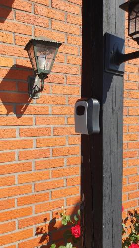 a light on the side of a brick wall at Sahlin - Kattarp in Kattarp