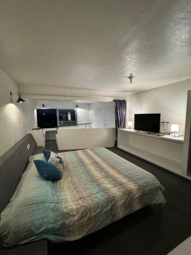 a bedroom with a bed with two pillows on it at casita briones in Xalapa