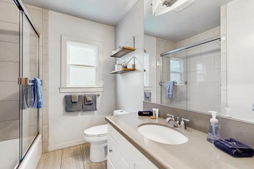a white bathroom with a sink and a toilet at Modern Wine Country Charmer in Healdsburg