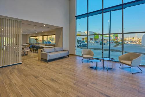 a lobby with a couch and chairs and a table at City Express by Marriott Tijuana El Florido in Tijuana
