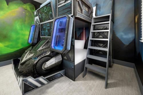 a room with a bunk bed and a desk with a laptop at Villatel Orlando Resort, Apartments by Marriott Bonvoy in Orlando