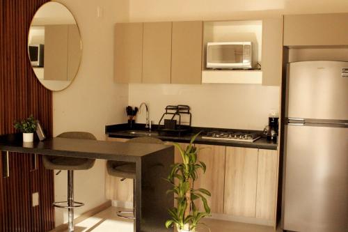 a kitchen with a refrigerator and a counter top at Loft Alberca in Chapultepec in Guadalajara