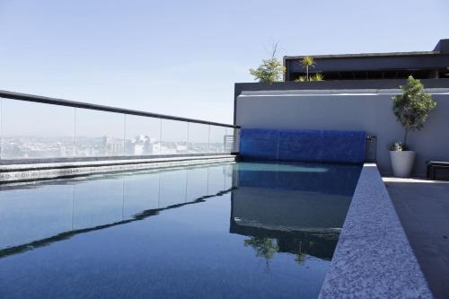 a swimming pool on the roof of a building at Loft Alberca in Chapultepec in Guadalajara