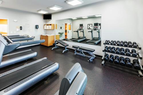 a gym with rows of treadmills and machines at TownePlace Suites by Marriott Tulsa Broken Arrow in Broken Arrow