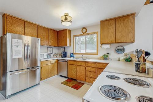 a kitchen with wooden cabinets and a stainless steel refrigerator at Poma Lane in Soda Springs