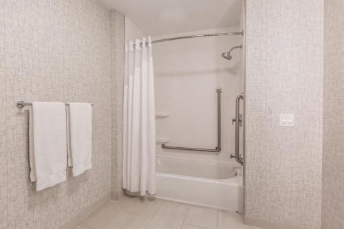 a bathroom with a shower and a shower curtain at Holiday Inn Express & Suites - Welland in Welland