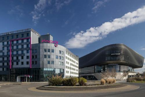 a large building with a pink bow on top of it at Moxy Southampton in Southampton