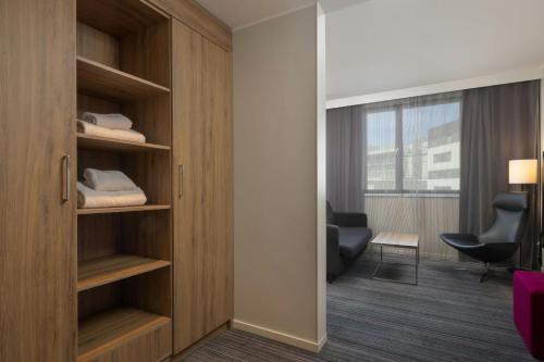 a room with a closet with a desk and a chair at Moxy Southampton in Southampton