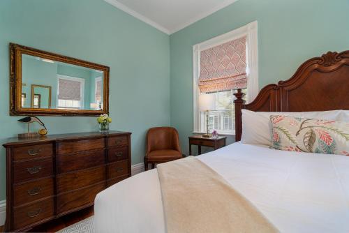 a bedroom with a bed with a mirror and a dresser at Nantucket Resort Collection in Nantucket