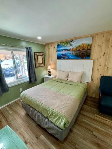 a bedroom with a bed and a painting on the wall at Homestead Inn - Blowing Rock in Blowing Rock