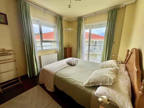 a bedroom with a bed and a large window at Apartamento El Corrillo - 5835 in Isla