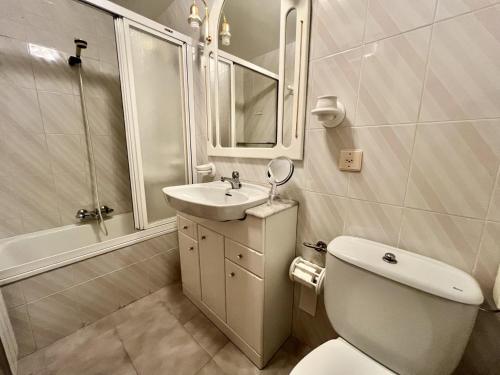 a bathroom with a toilet and a sink and a shower at Apartamento El Corrillo - 5835 in Isla