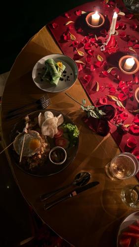 a table with a plate of food on top of it at Punduk Villa - The Manta in Selat