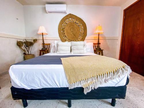 a bedroom with a large bed with a large headboard at Gorgeous and Equipped 3BR Villa With Private Pool and Patio in Mérida