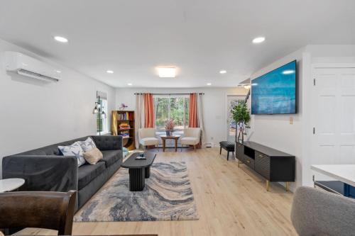 a living room with a couch and a table at Breathtaking Riverfront Hideaway in Wareham in Wareham