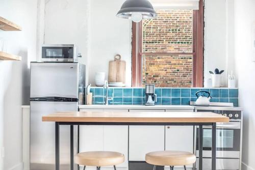 a kitchen with a table and two stools at Annabelle 3B - New in Savannah