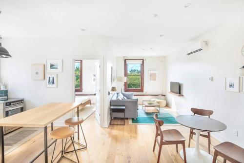 a kitchen and living room with a table and chairs at Annabelle 3B - New in Savannah