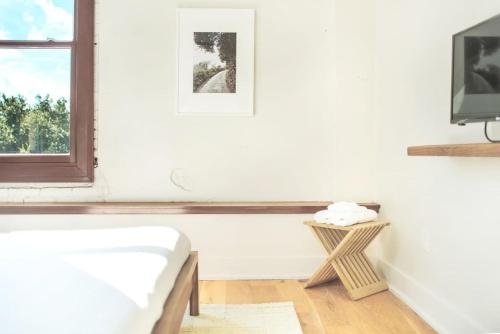 a white room with a white couch and a window at Annabelle 3B - New in Savannah