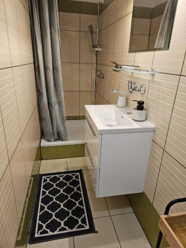 a small bathroom with a sink and a shower at Domki u Magdy in Ustka